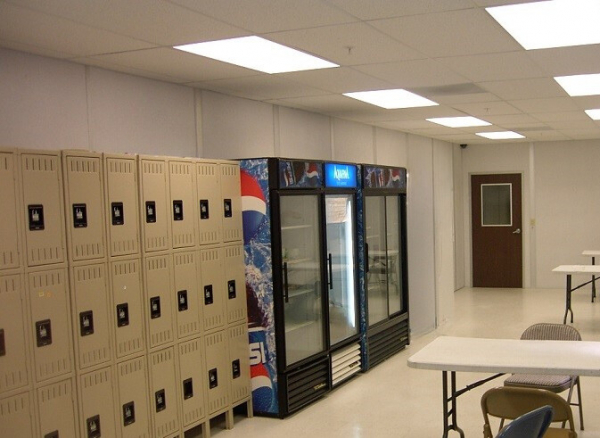 Locker room with lockers, refrigerators, tables and chairs